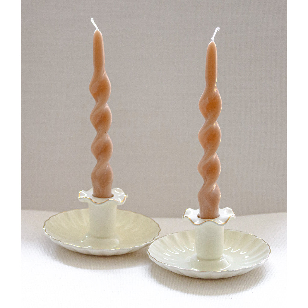 Cream ceramic candle holders with fluted center stems and gold-tone edge details