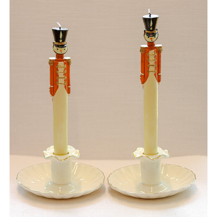 Pair of cream ceramic candle holders with pedestal stems and gold-tone edge details