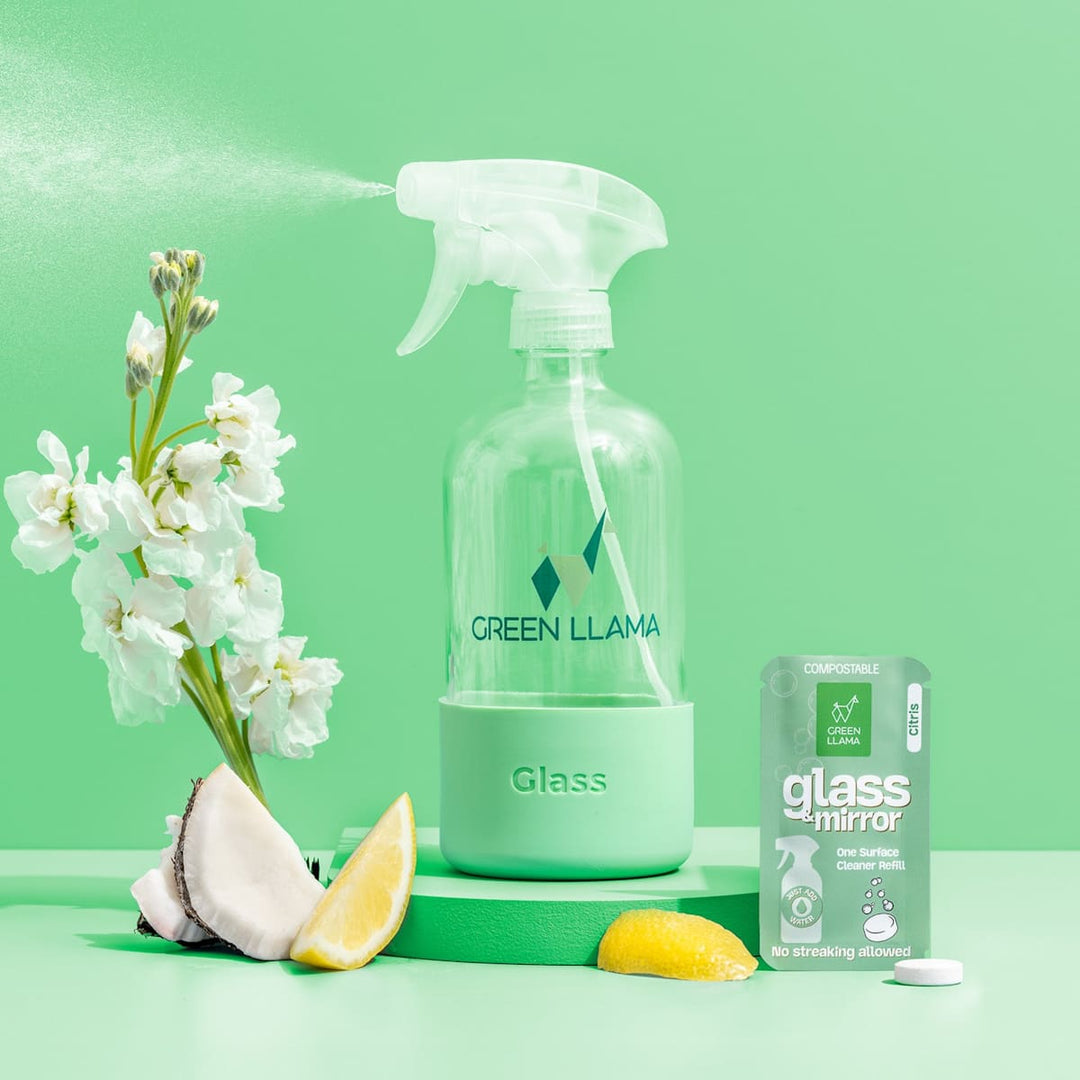 Green Llama glass & mirror spray bottle with box, tablet, and lemon for cleaning.