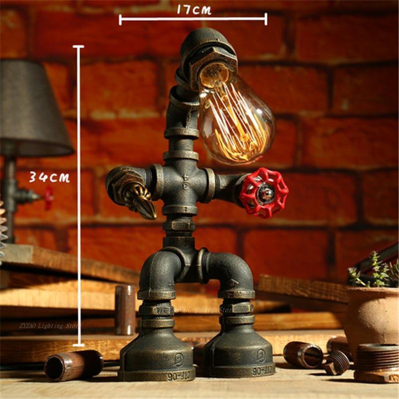 Bronze steampunk table lamp with glowing bulb, red switch, and pipe arms on base.