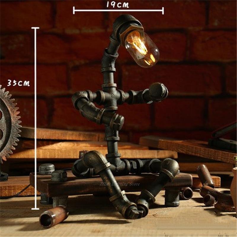 Bronze steampunk table lamp with warm bulb, branching iron tubes and gear accents.