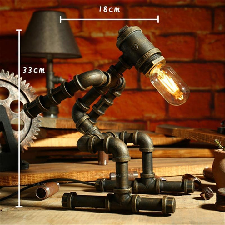 Bronze steampunk lamp with warm bulb on tall articulated arm and cylindrical tube parts.