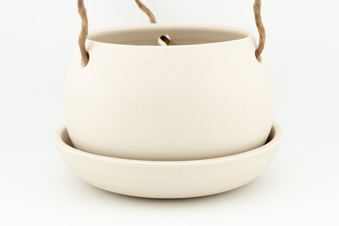 White unglazed ceramic hanging planter pot with rope handles and drain hole