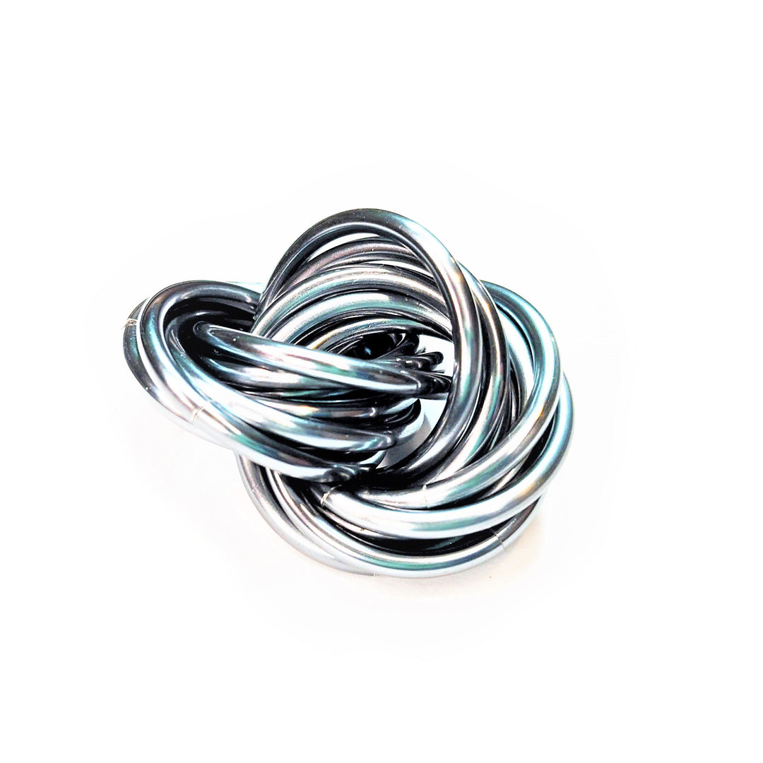 Swirled metallic fidget stress ball, black and silver loops with subtle blue sheen
