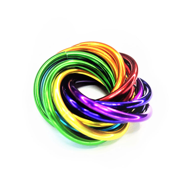 Shiny multicolor fidget stress ball with bright glossy rainbow rings, top view.