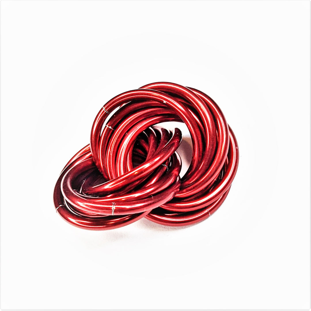 Metallic red twisted stress ball fidget toy, coiled rings shape