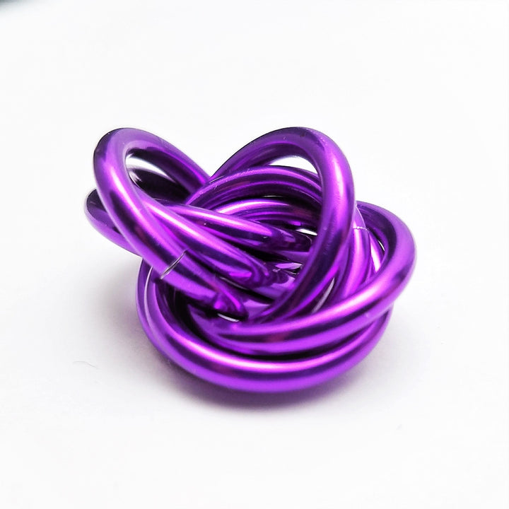 Metallic purple twisted stress ball fidget toy, coiled rings shape