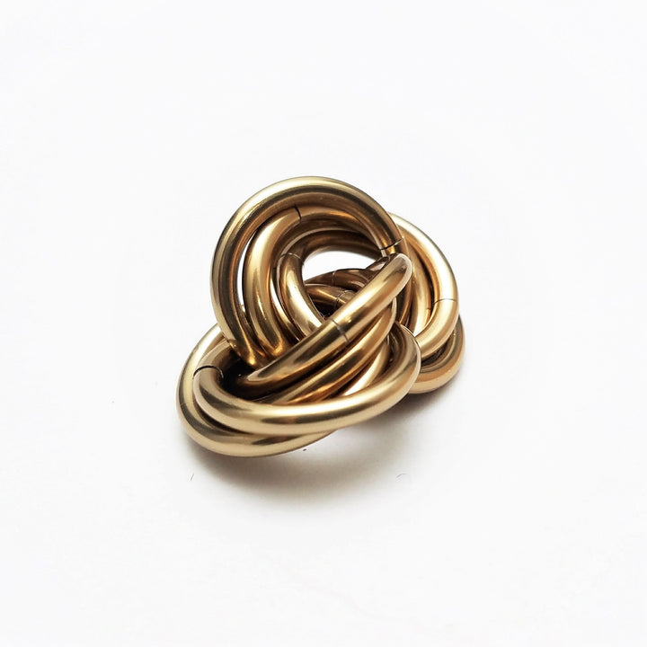 Metallic bronze twisted stress ball fidget toy, coiled rings shape