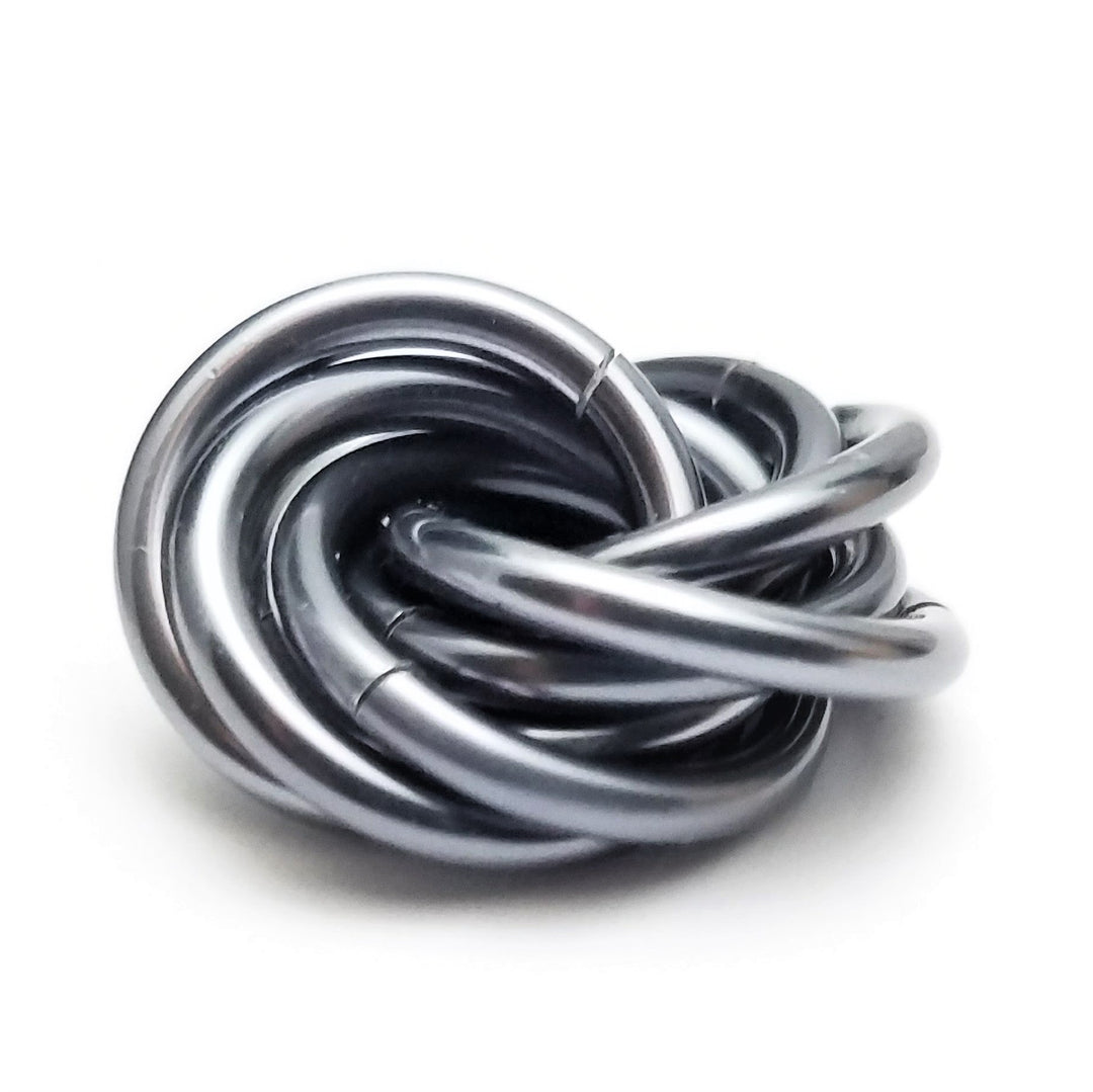 Silver-gray metallic stress fidget ball with coiled loop design