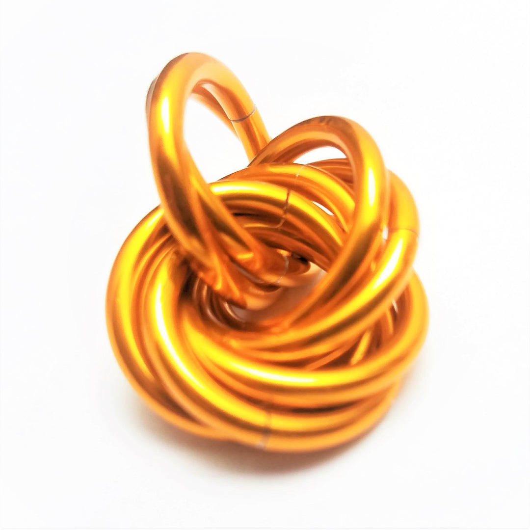 Metallic orange twisted stress ball fidget toy, coiled rings shape