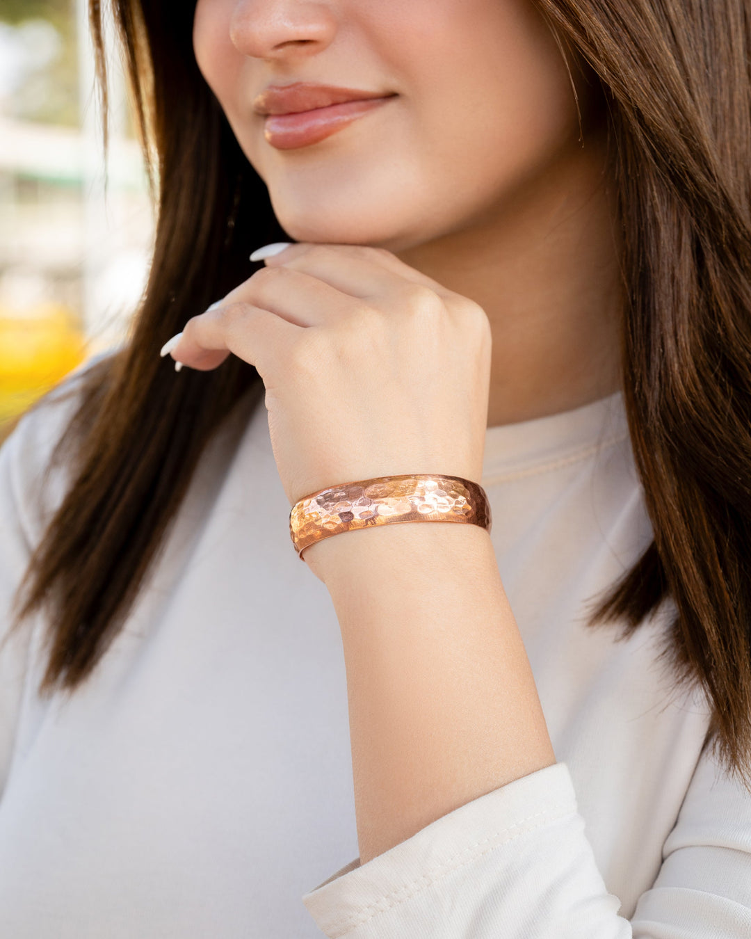 Hammered copper cuff bracelet worn on wrist, wide textured copper bangle