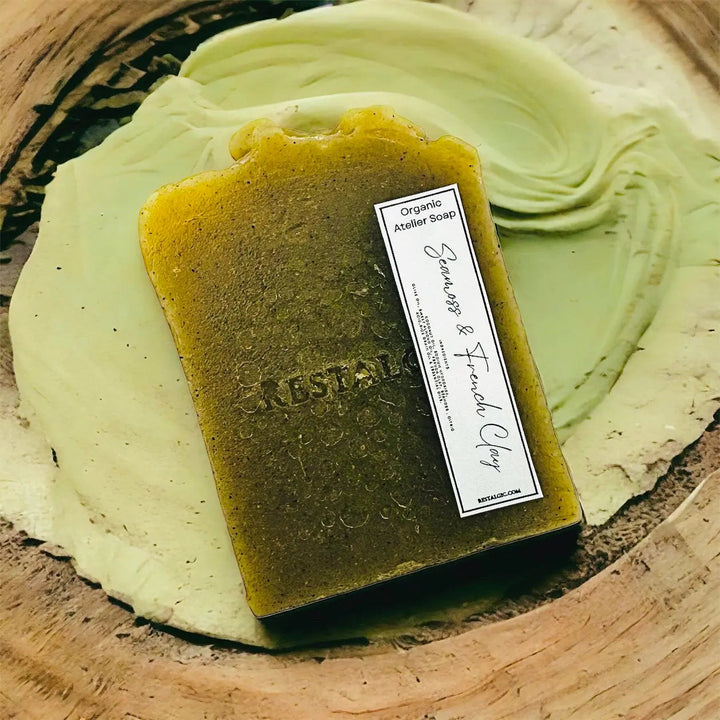 Handcrafted natural soap bar, olive green with speckles and a rectangular white product label