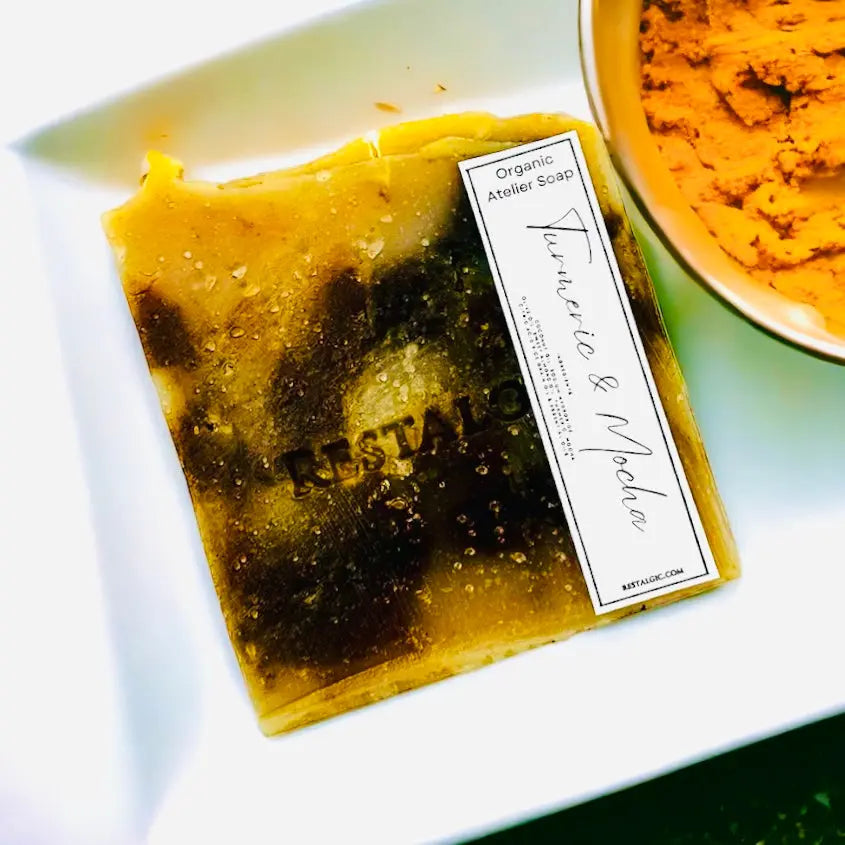 Handcrafted natural soap bar, golden yellow with darker patches and a rectangular white product label