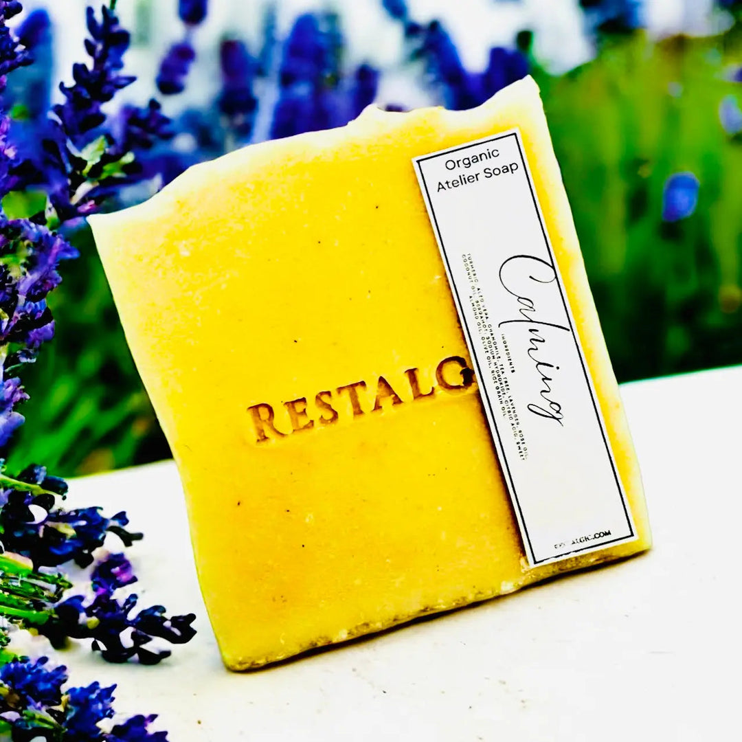 Yellow handcrafted natural soap bar with organic Atelier Soap label.