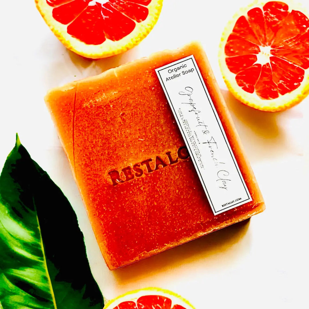 Handcrafted natural soap bar, orange-red with speckles and rectangular white product label