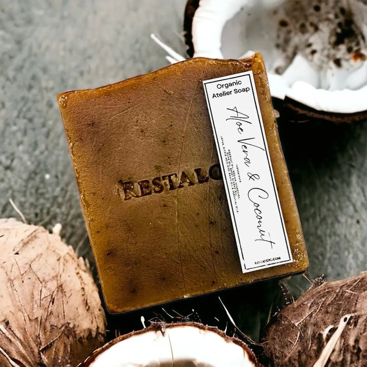 Dark brown handcrafted natural soap bar with organic Atelier Soap label.