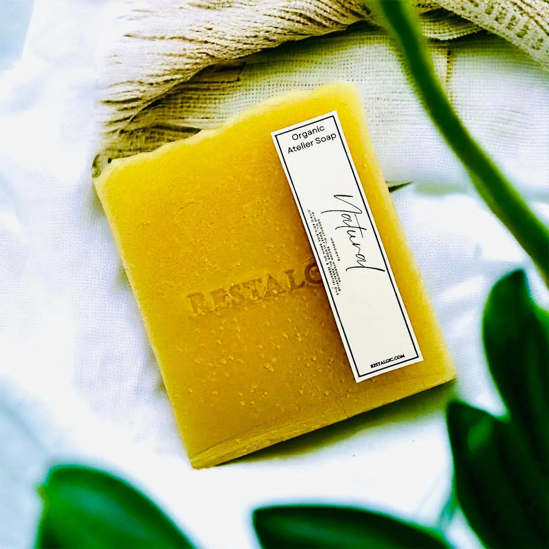 Handcrafted natural soap bar, bright yellow with a white rectangular product label