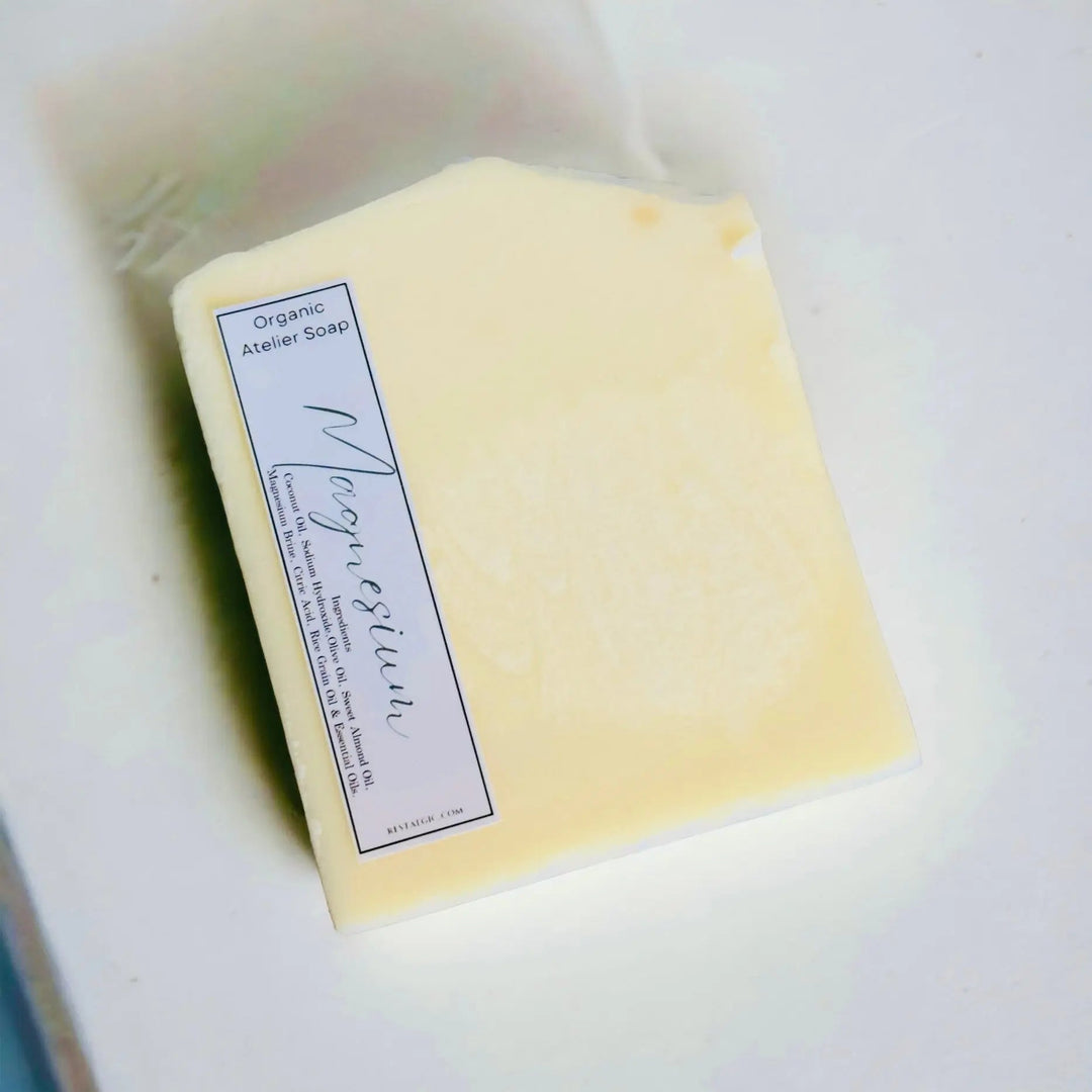 Cream handcrafted natural soap bar with organic Atelier Soap label.