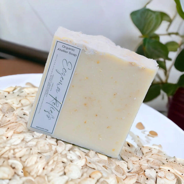 Cream handcrafted natural soap bar with organic Atelier Soap label.