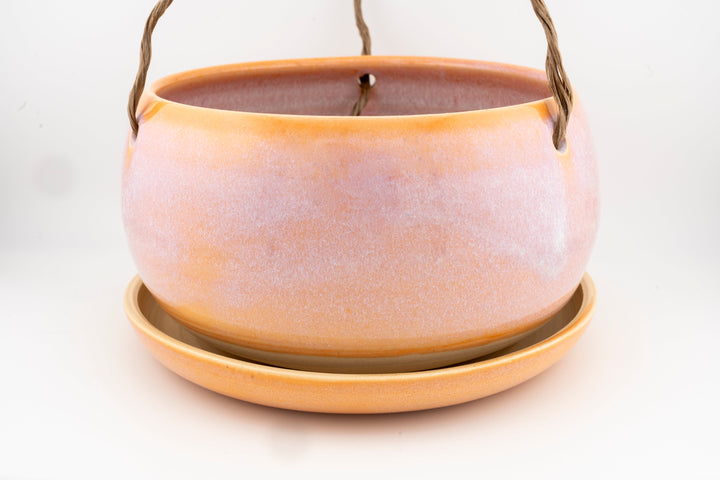 Glazed hanging planter with rope handles and round saucer base, peachy orange