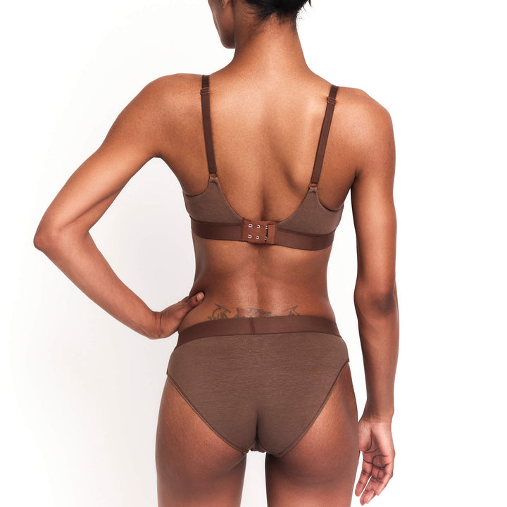 Dark brown mid-rise brief from the back with seamless fit and high-cut legs.