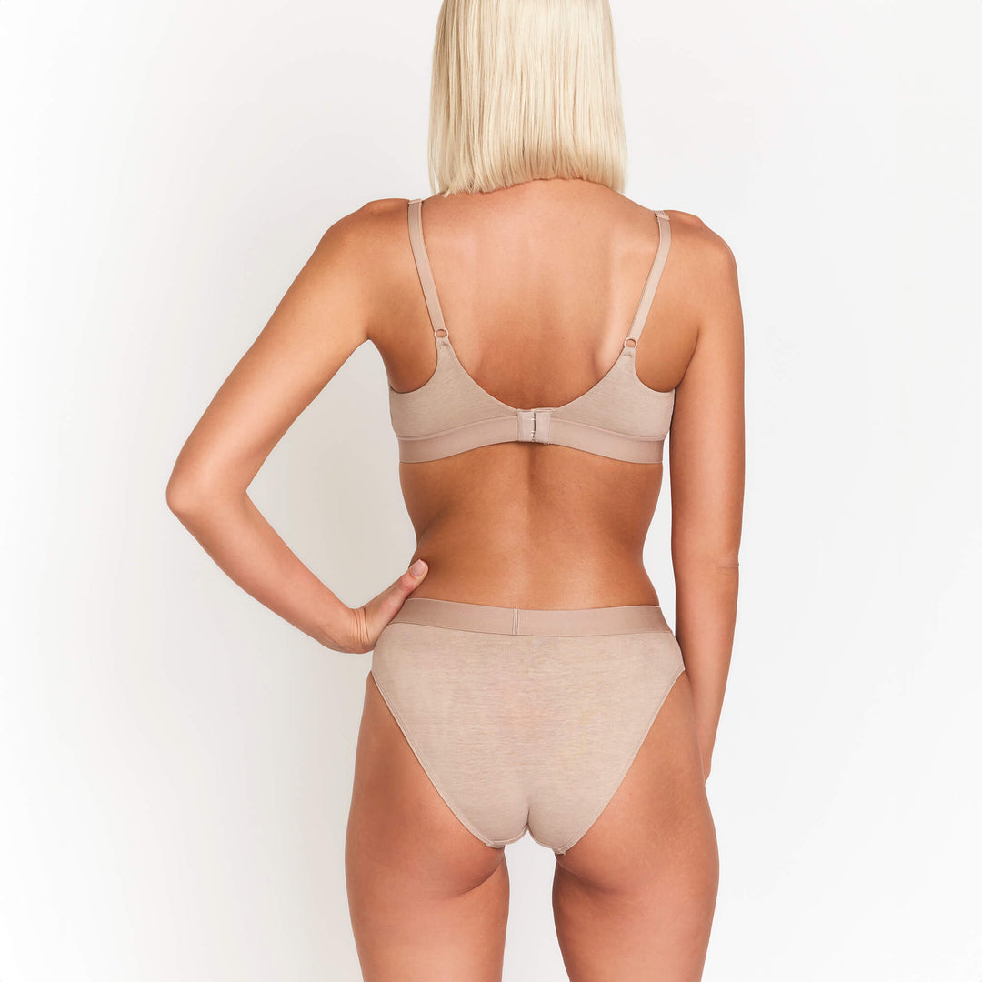 Mid-rise briefs, smooth tan stretch fabric, back view with elastic waistband