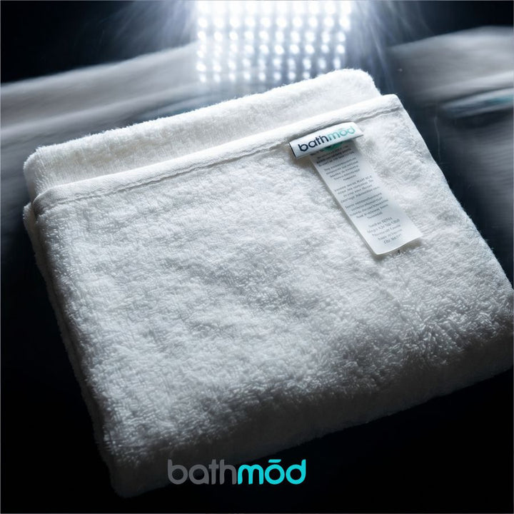 White bath mat bundle, folded with fabric label on top
