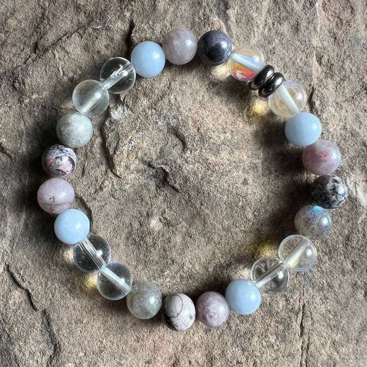 Round-stone bracelet with light-blue beads, gray speckled stones, and clear crystal accents