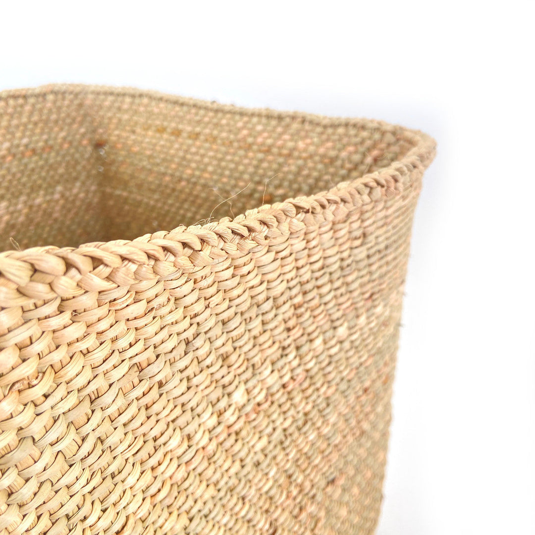 Woven basket rim and side weave detail in natural tan fiber