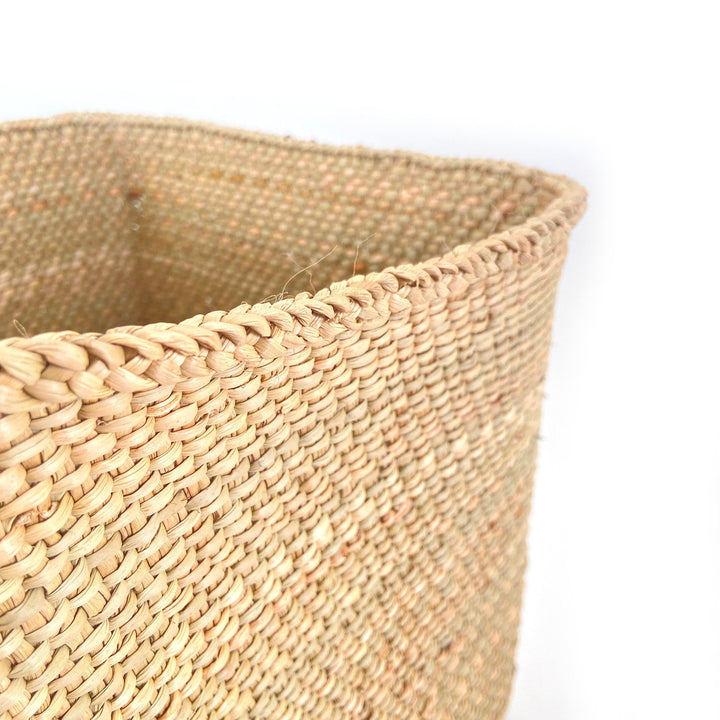 Woven basket rim and side weave detail in natural tan fiber