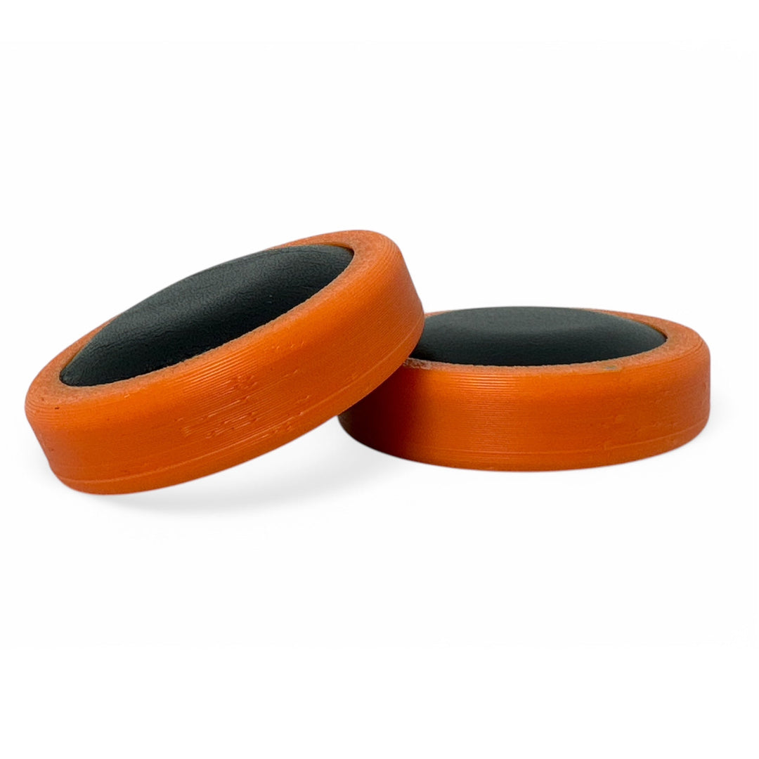 Fidget toy moon discs, black inner with orange outer, two-piece pair