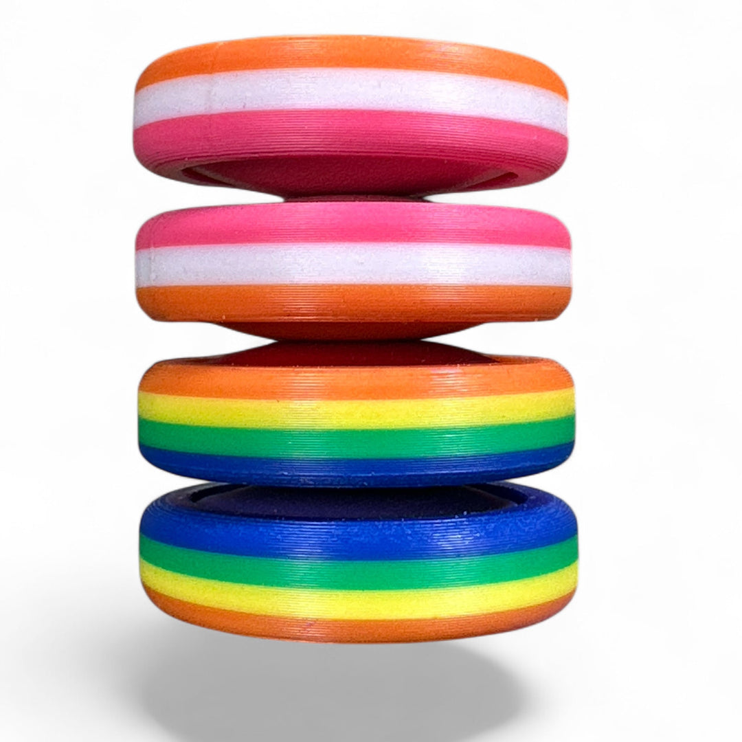 Stack of pride rainbow striped round bands in orange, pink, green, and blue