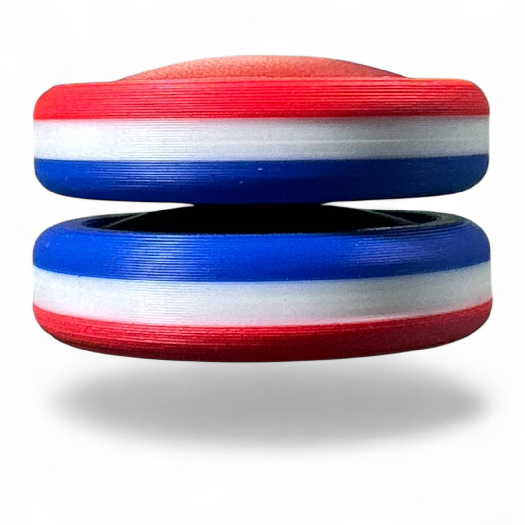 Stacked red, white, and blue striped round toy with two oval openings