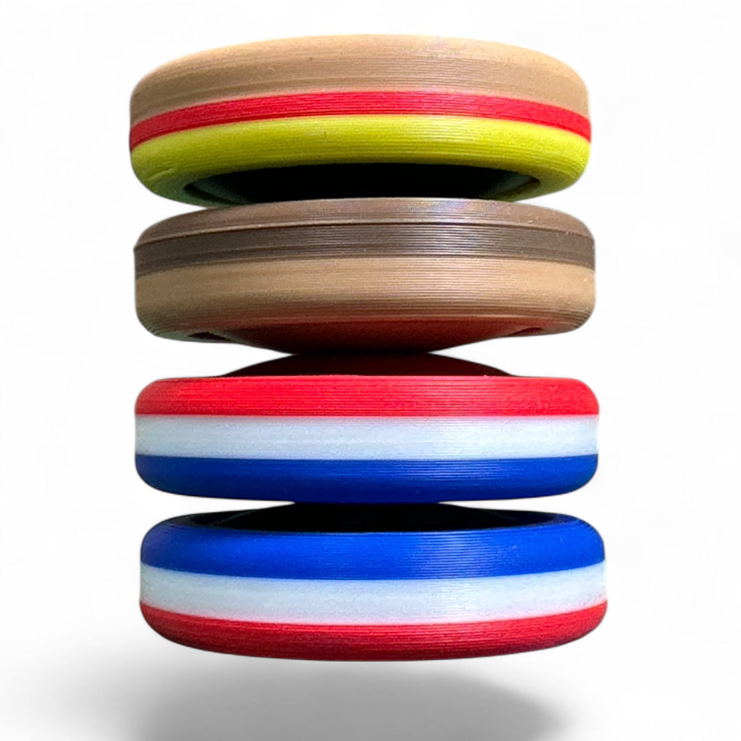 Stacked tan, red, white, green, and blue striped round toy