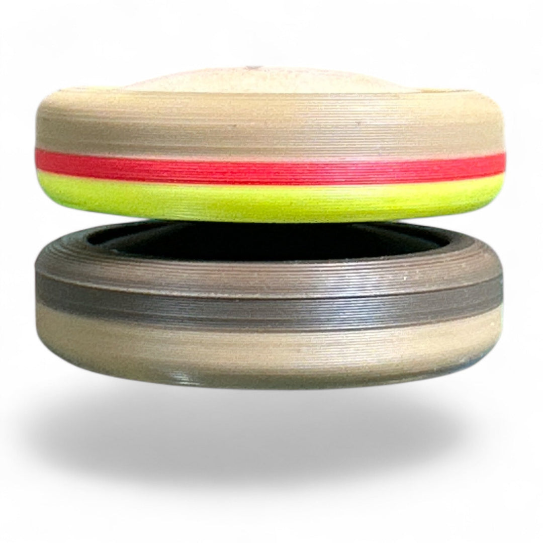 Tan and gray striped round stacking toy with green and red stripe detail