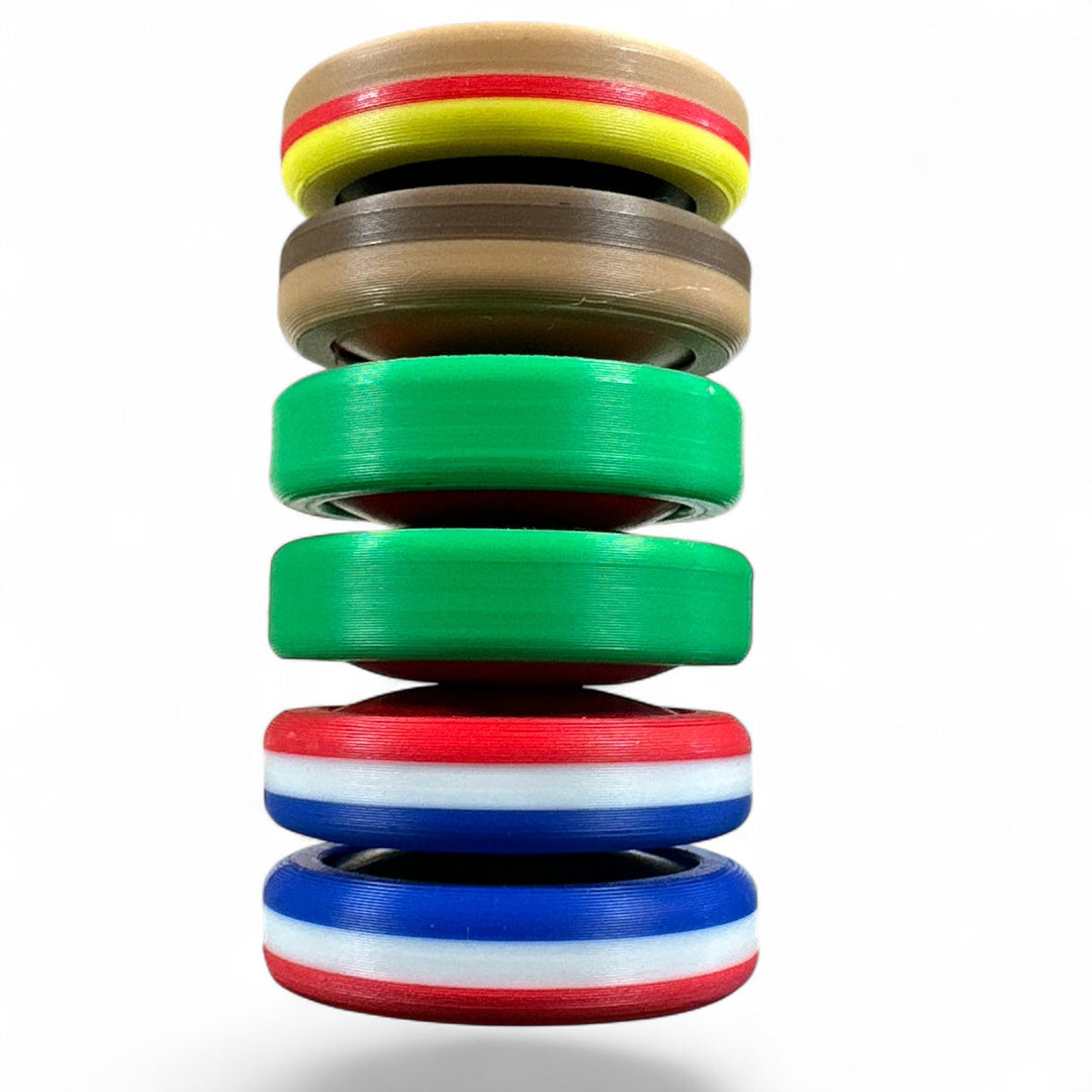 Stack of striped plastic discs in green, red, blue, and yellow with central opening