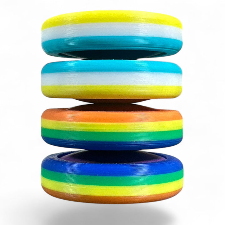 Stack of pride rainbow striped round bands in yellow, light blue, orange, green, and navy