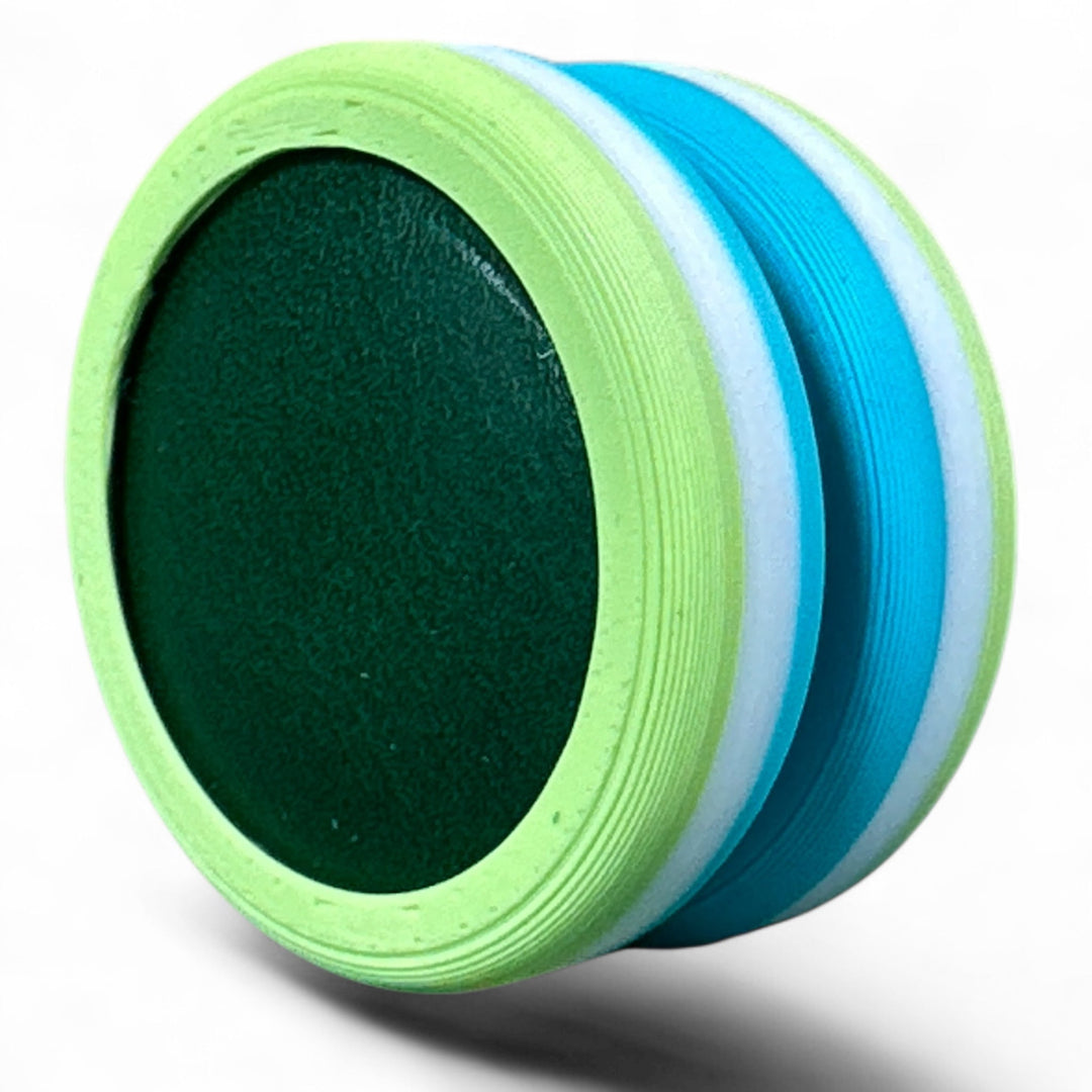 Close-up of pride round band with black center and lime green, light blue, and white stripes