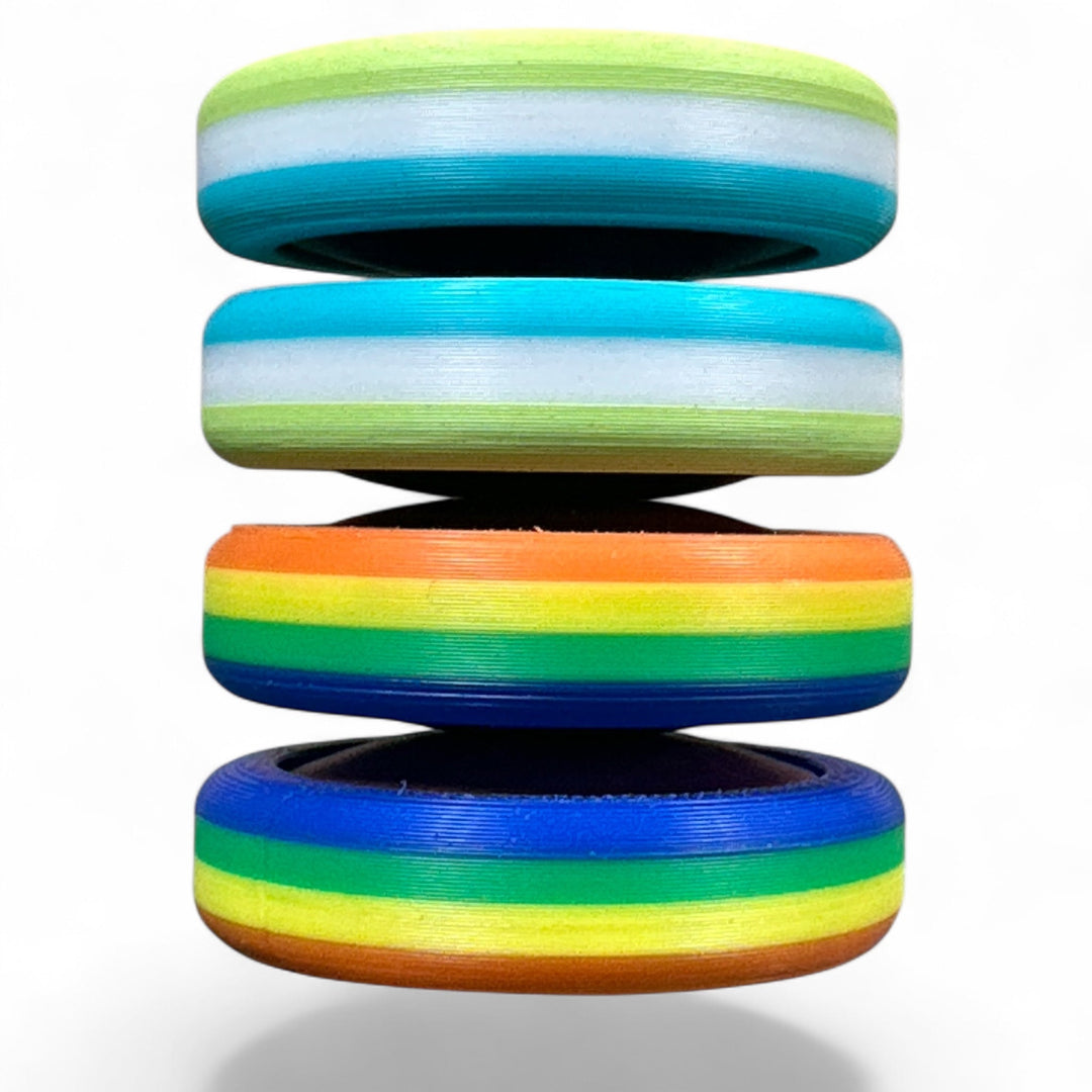 Stack of pride rainbow striped round bands in light green, blue, orange, and rainbow colors