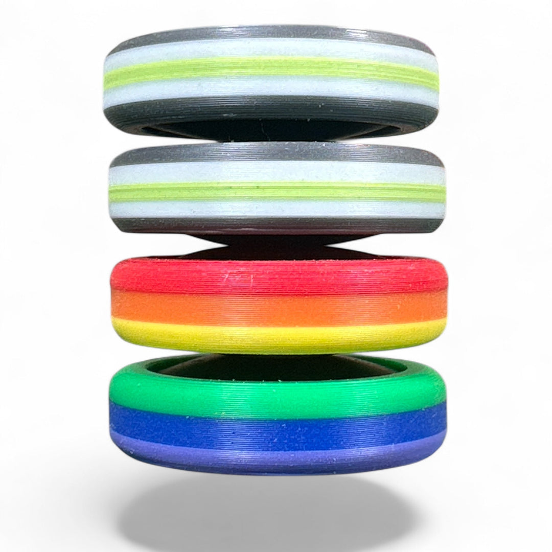 Pride Moons stacked rainbow discs with red, green, blue, and gray stripes