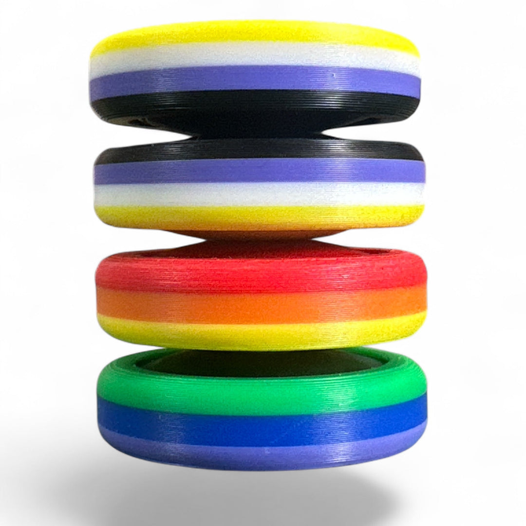 Pride Moons stacked rainbow discs with yellow, purple, red, green, and blue stripes