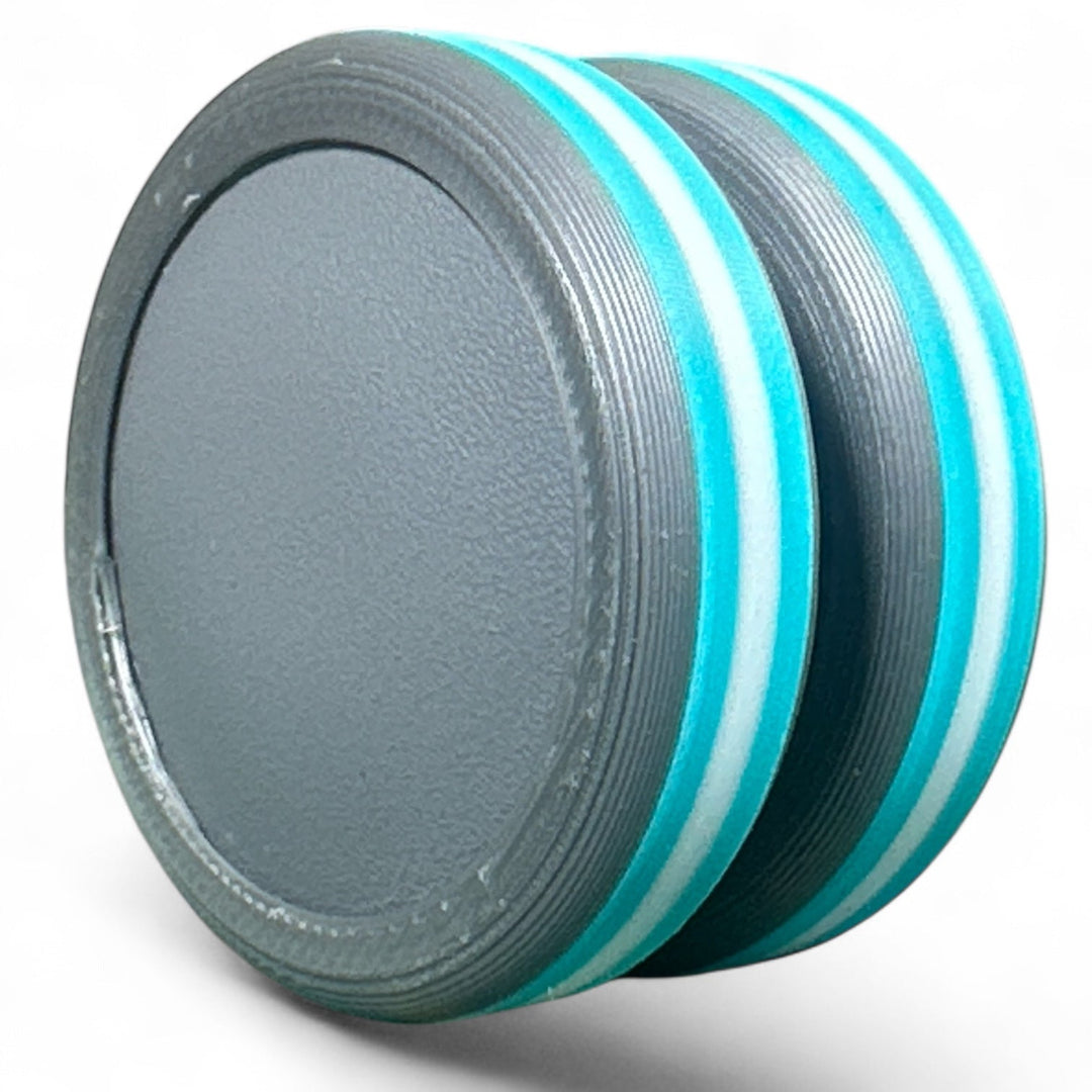 Striped pride ear plug with light blue and white rings over dark gray base