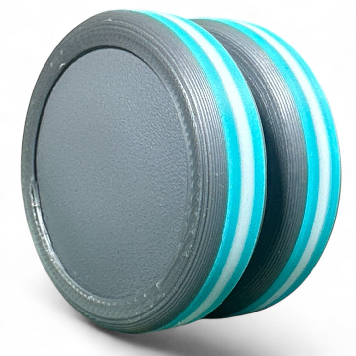 Striped pride ear plug with light blue and white rings over dark gray base
