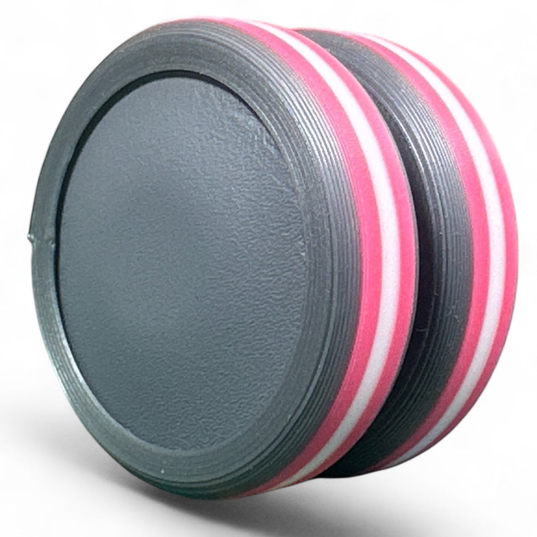 Striped pride ear plug with pink and white rings over dark gray base
