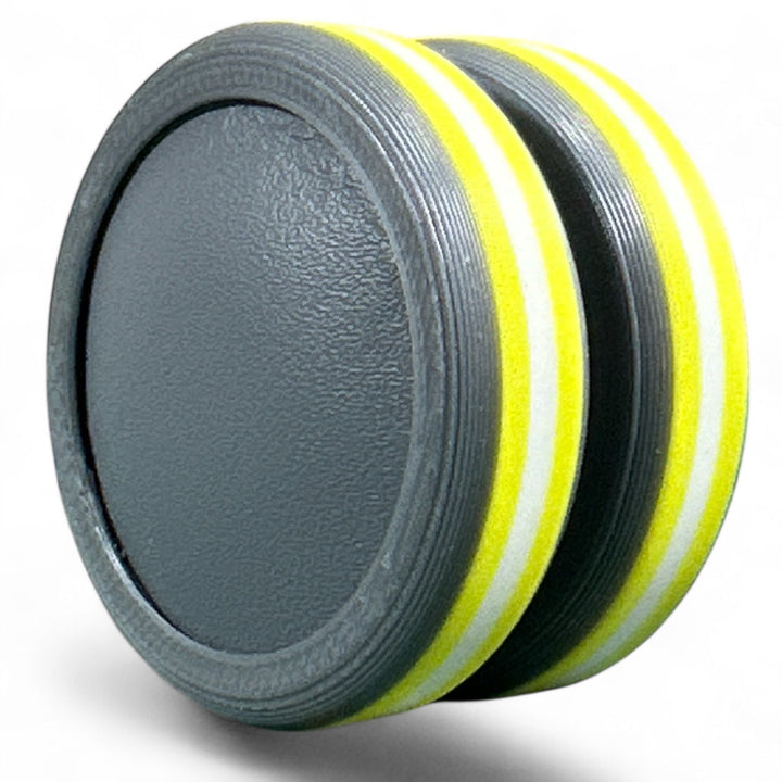 Striped pride ear plug with yellow and white rings over dark gray base