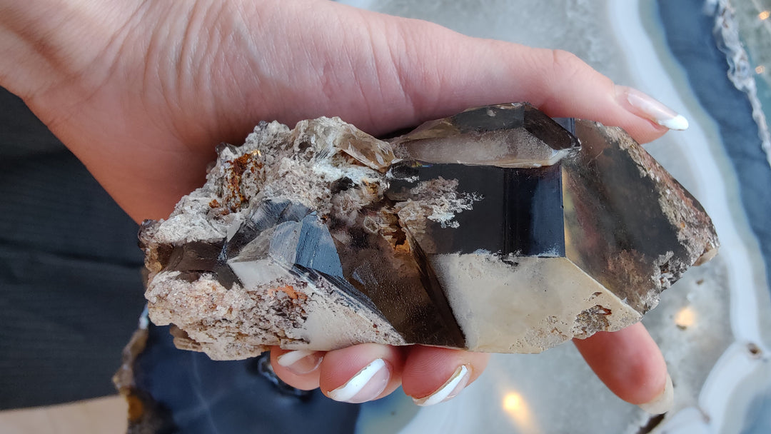 Smoky quartz point with clear smoky step-cut faces on rugged rock