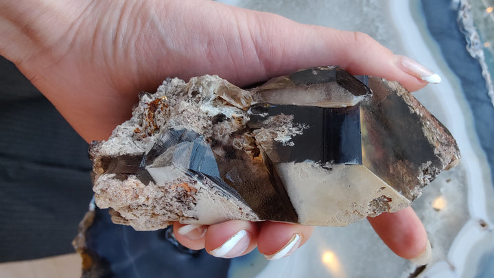 Smoky quartz point with clear smoky step-cut faces on rugged rock