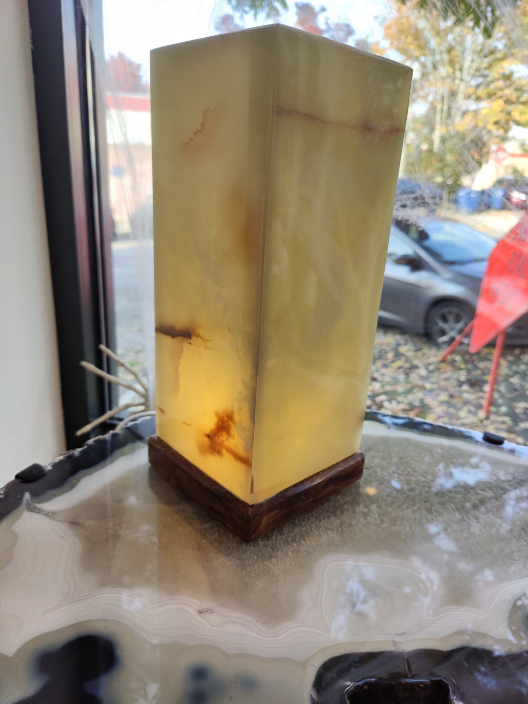 Square onyx table lamp with green-gold stone panels and dark wooden base