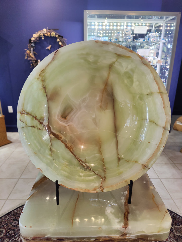 Green onyx decorative bowl with translucent pale green surface and natural veining