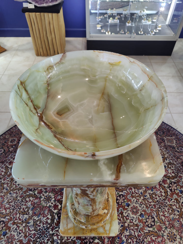 Round green onyx decorative bowl, pale green with swirling natural stone veining